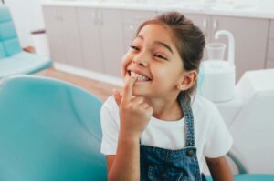 Children pointing her teeth After Flouride Treatments